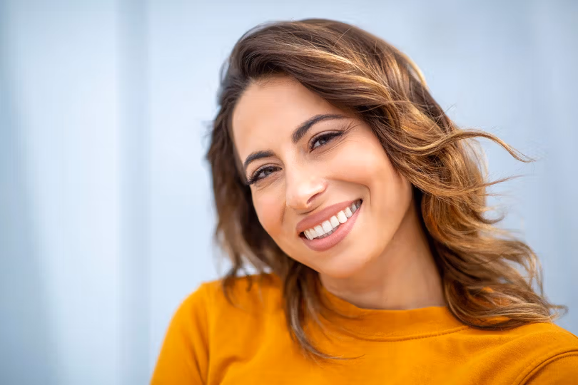 Woman smiling after cosmetic dental care