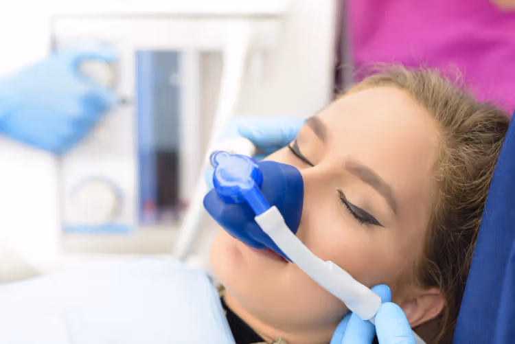 Patient receiving nitrous oxide sedation during dental treatment
