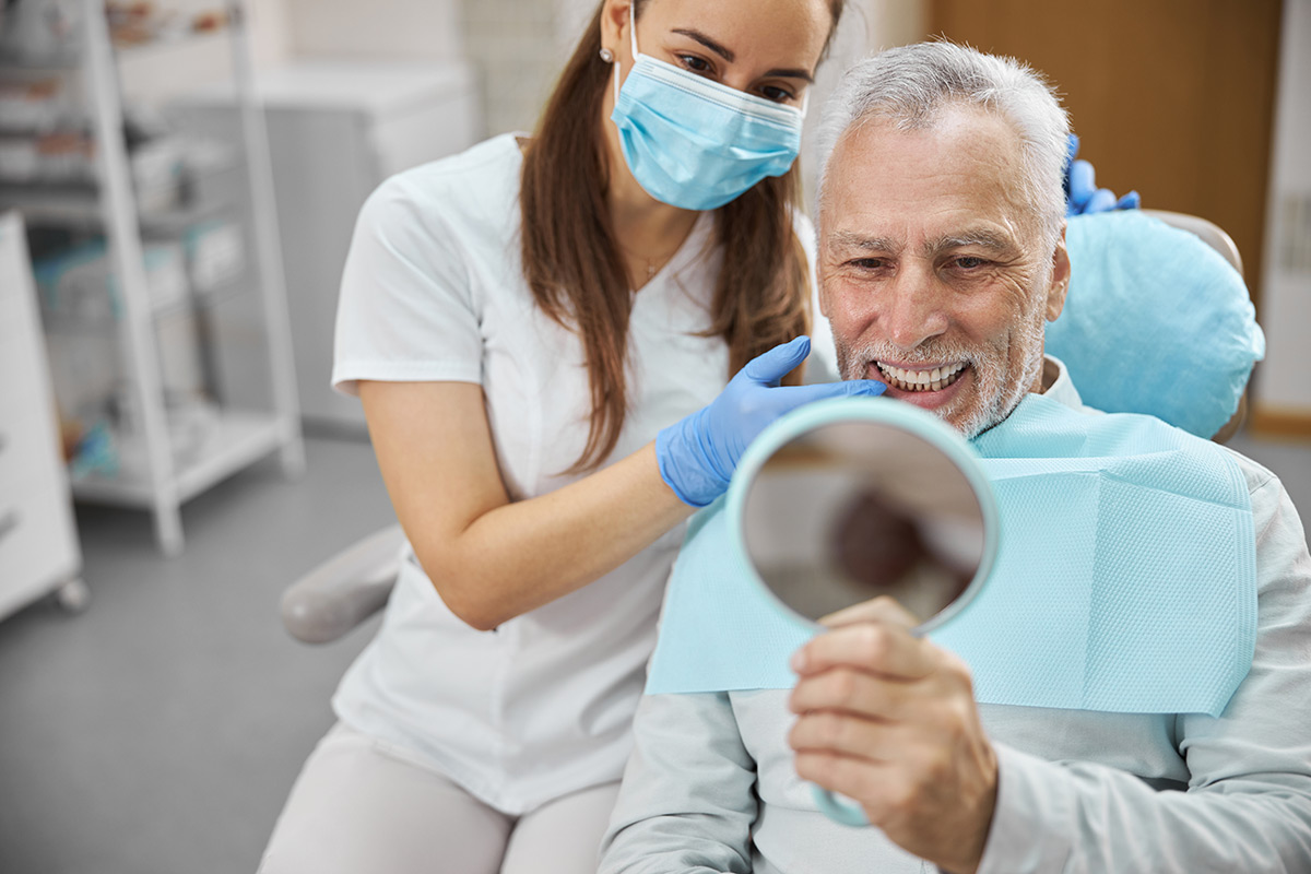 Patient viewing his restored smile during a dental visit