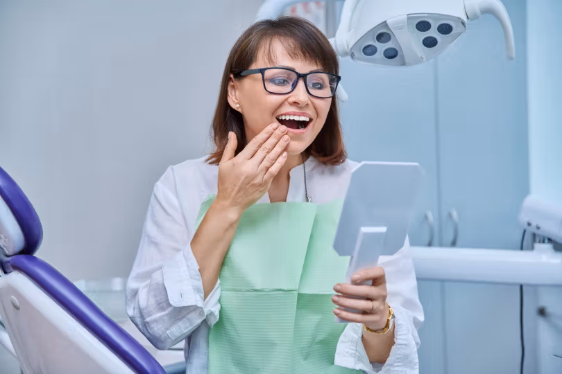 Patient reacting happily while reviewing her dental results