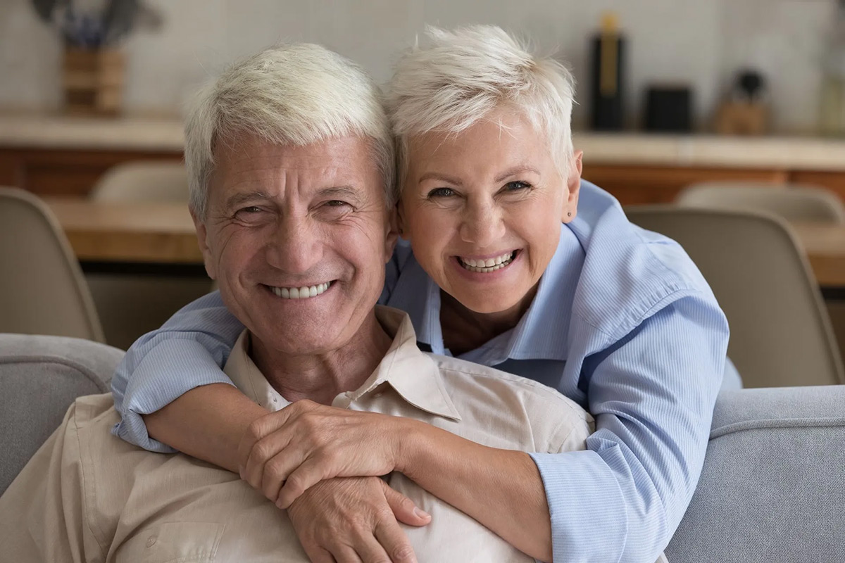 Older couple smiling together at home
