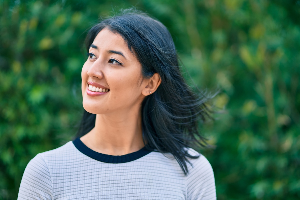 Woman smiling after cosmetic dental care