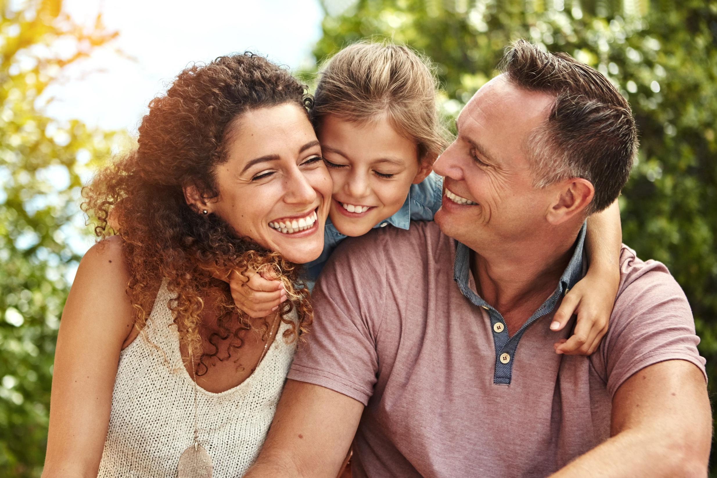 Family smiling together outdoors