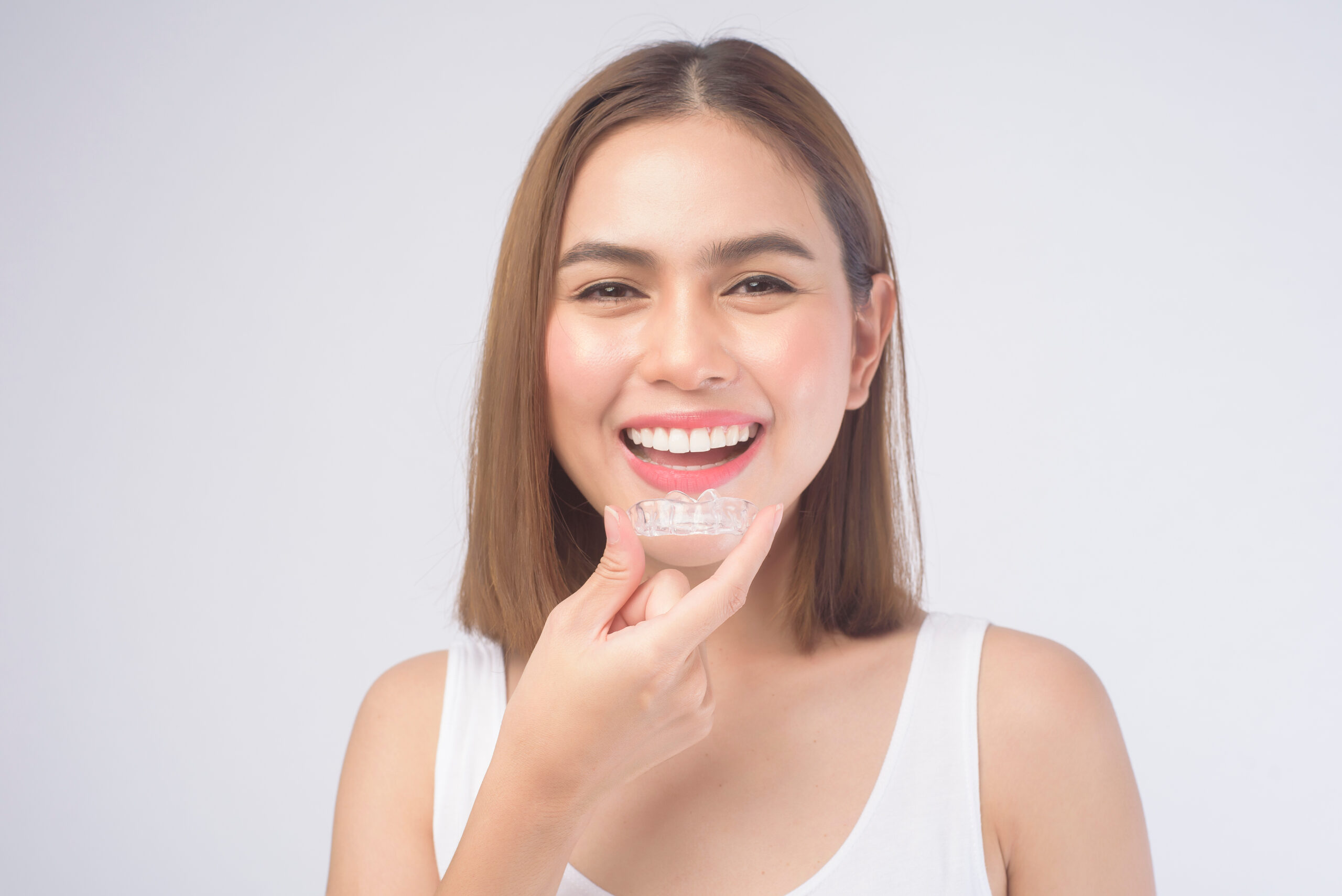 Woman smiling after clear aligner treatment