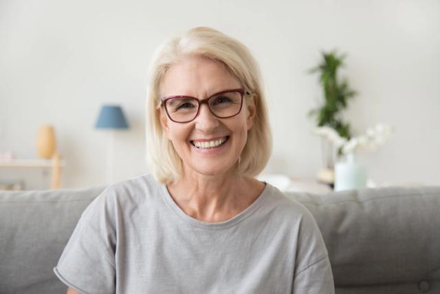 Older woman smiling after restorative dental care
